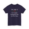 Unisex t-shirt from Twisted Angell with the sarcastic phrase “Most Likely To Get Caught Wrapping Gifts On The Clock” printed on the front.
