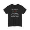 Unisex t-shirt from Twisted Angell with the sarcastic phrase “Most Likely To Get Caught Wrapping Gifts On The Clock” printed on the front.
